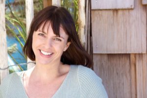 Woman smiling with tooth pain and discomfort