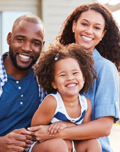 Family smiling because the are a part of Gallagher & Kuhn's Dental Membership Plan.